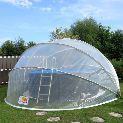 Dome-shaped pool cover over an above-ground pool with a ladder, set outdoors.