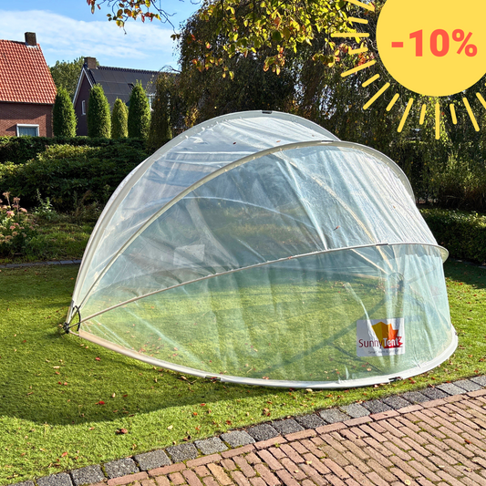 SunnyTent S - Jacuzzi dome on a grassy area with a brick building in the background