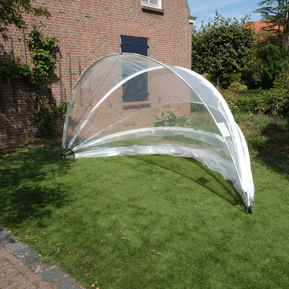 SunnyTent S - Jacuzzi dome on a grassy area with a brick building in the background